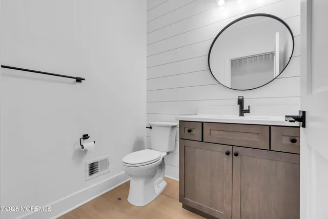 a bathroom with a sink toilet and a mirror