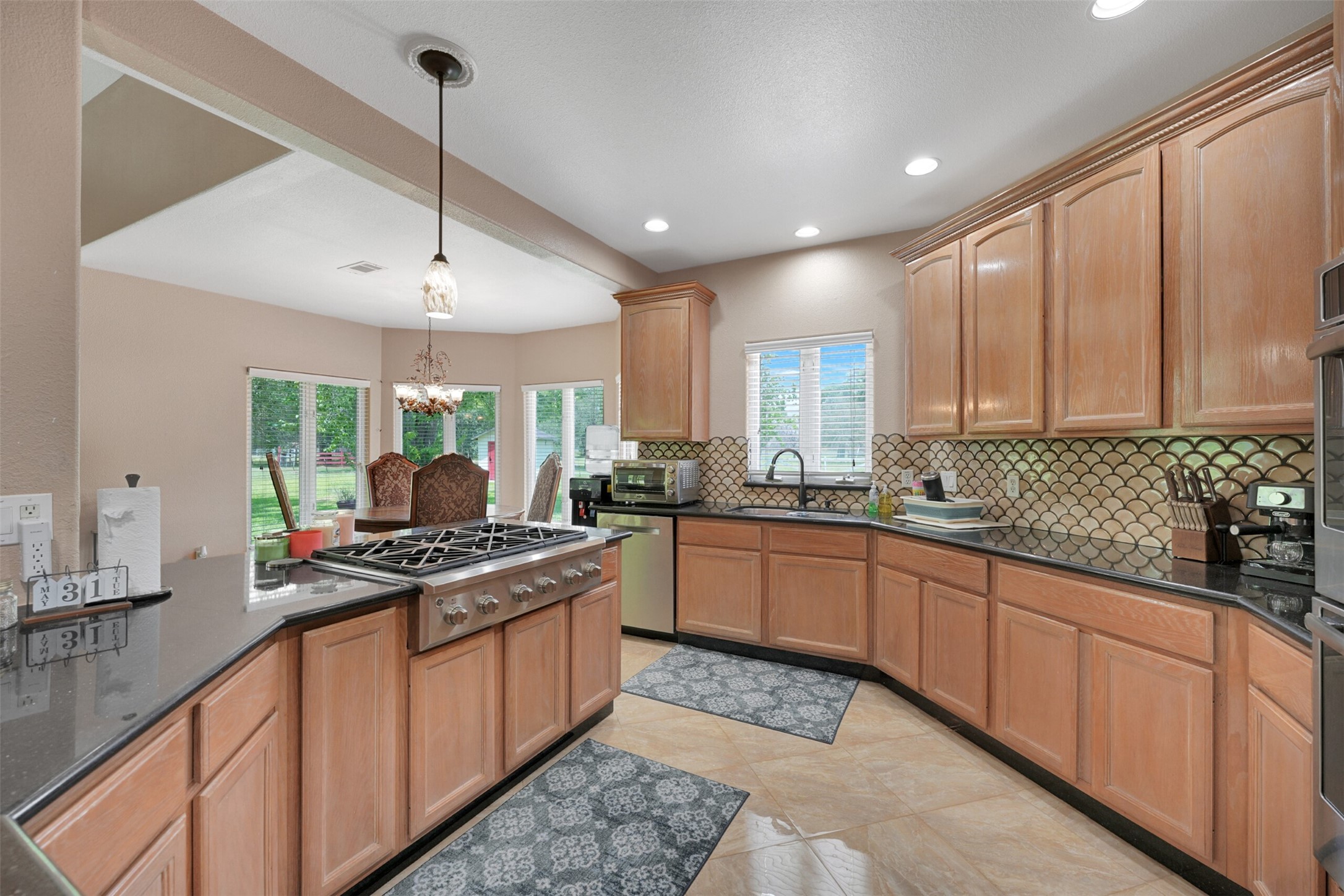 2750 County Road 48 Rosharon, TX 77583 - Photo 14 of 40 a kitchen with stainless steel appliances granite countertop a stove a sink and a refrigerator