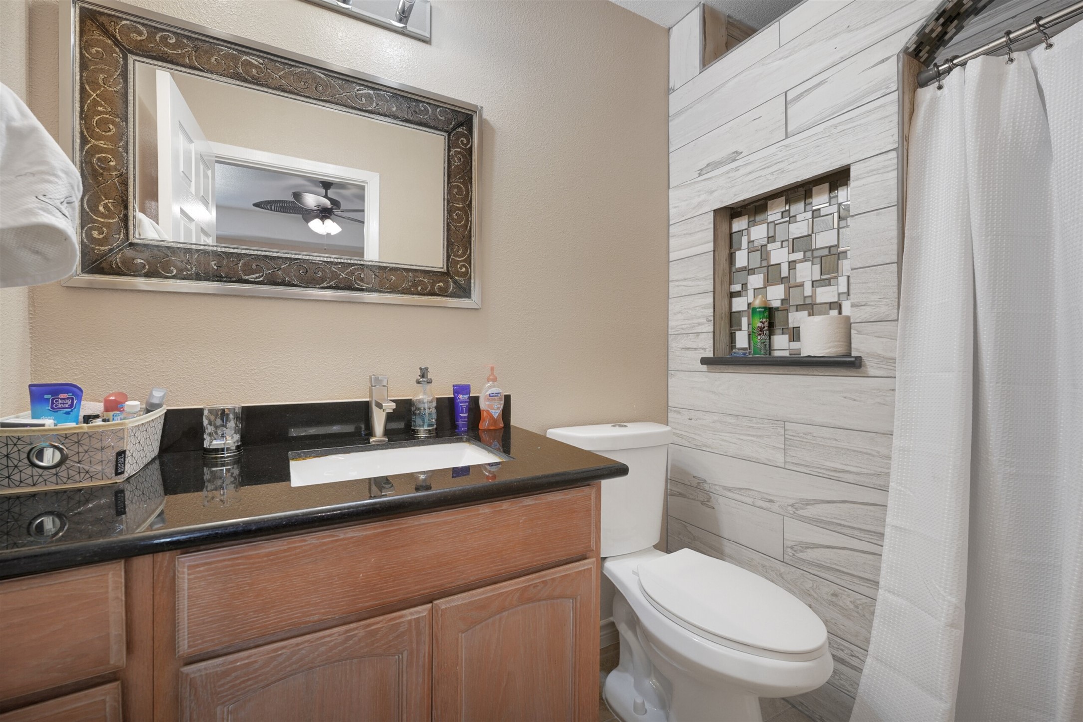 2750 County Road 48 Rosharon, TX 77583 - Photo 31 of 40 a bathroom with a granite countertop toilet sink and mirror
