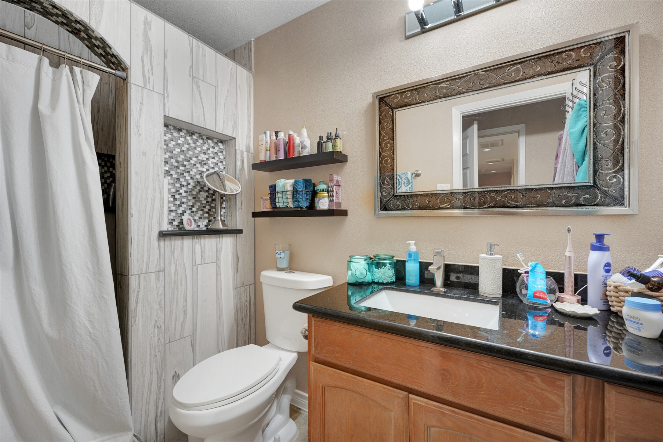 2750 County Road 48 Rosharon, TX 77583 - Photo 33 of 40 a bathroom with a toilet a sink and a mirror