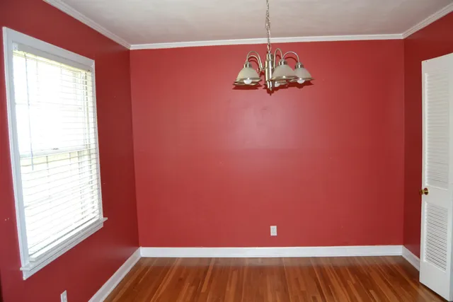 a view of a room with wooden floor and windows