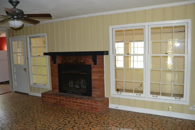 a living room with a fireplace and a window
