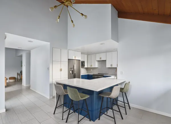 a kitchen with a dining table cabinets and appliances