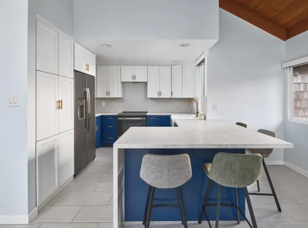 a kitchen with stainless steel appliances granite countertop a sink a refrigerator and a stove