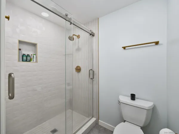 a white toilet sitting next to a bathroom sink
