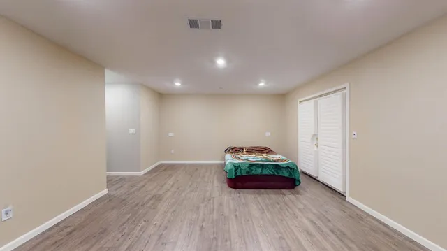 a bedroom with bed and window