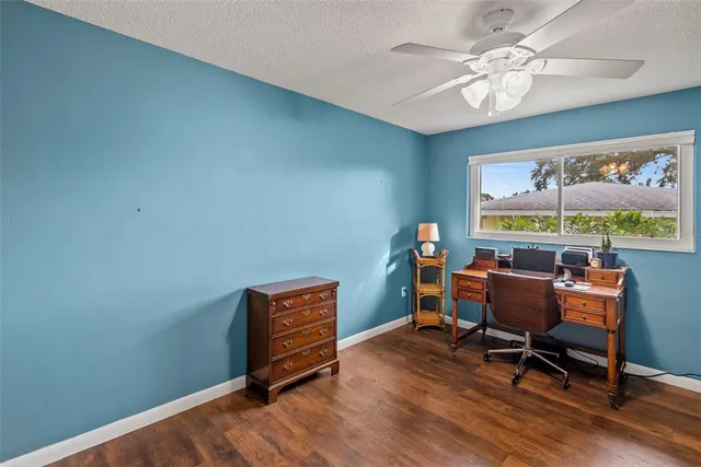 a view of a patio with a table and chairs under an umbrella