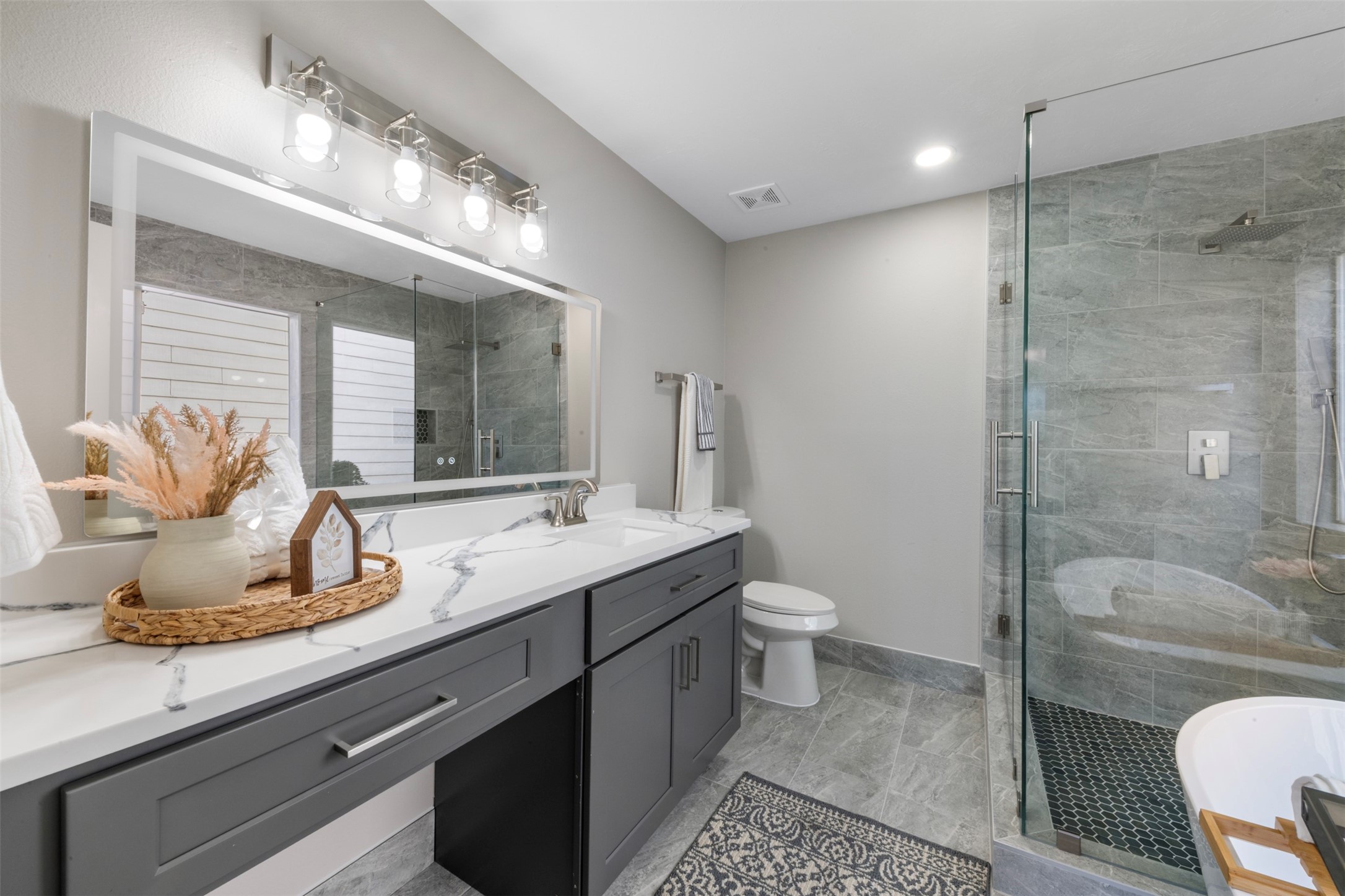 9606 Farrell Drive Houston, TX 77070 - Photo 14 of 37 a bathroom with a granite countertop sink a toilet and shower