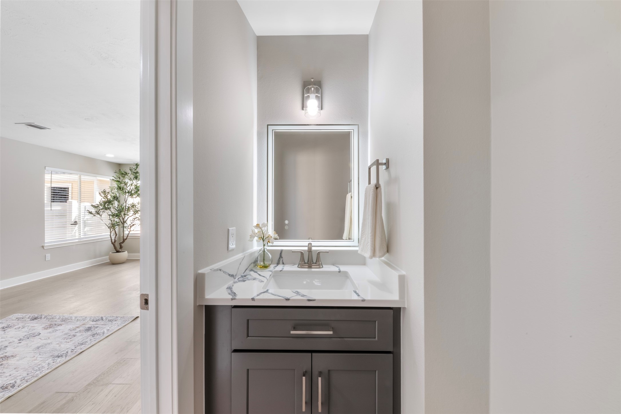 9606 Farrell Drive Houston, TX 77070 - Photo 16 of 37 a bathroom with a granite countertop sink and a mirror