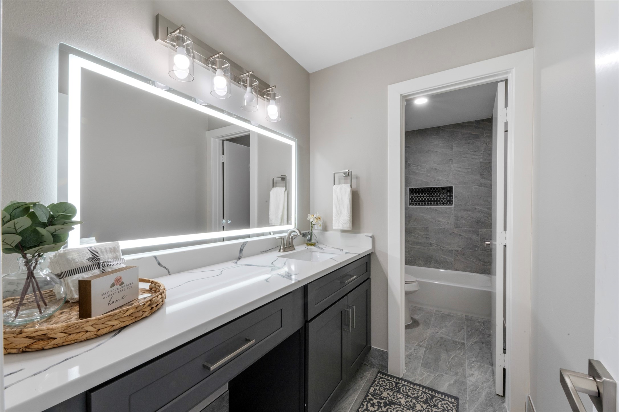 9606 Farrell Drive Houston, TX 77070 - Photo 23 of 37 a bathroom with a sink and a mirror