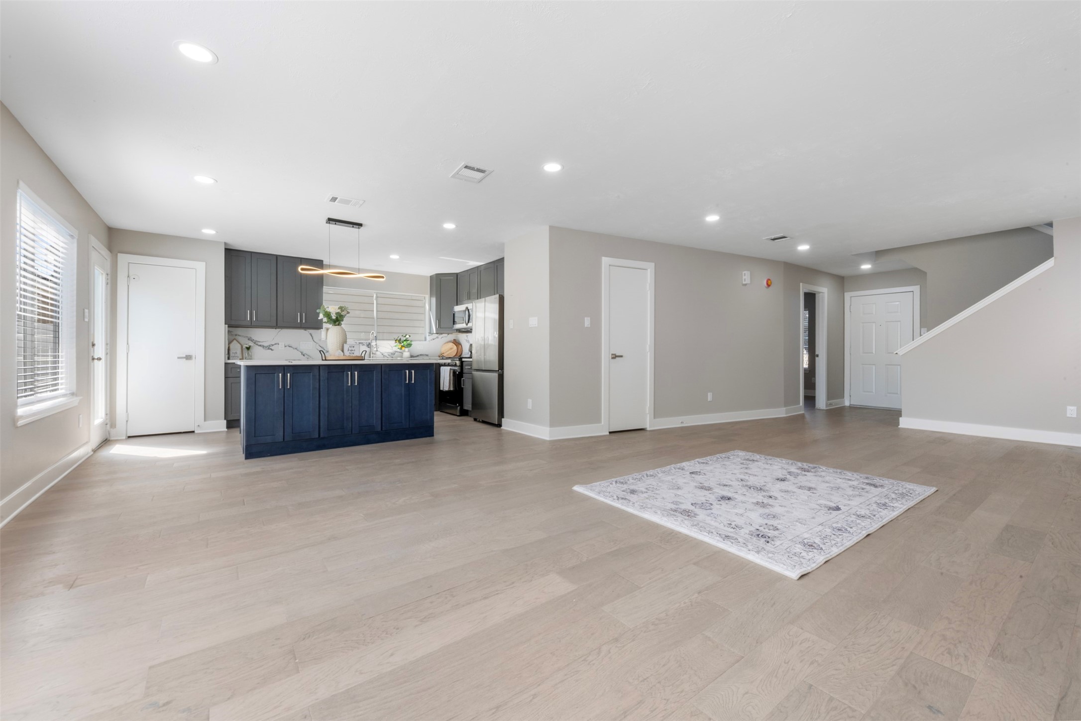 9606 Farrell Drive Houston, TX 77070 - Photo 6 of 37 a view of kitchen and hall with stainless steel appliances wooden floor