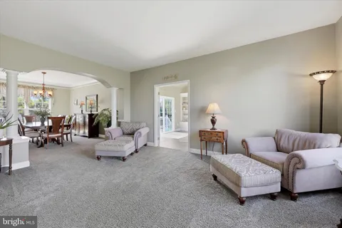 a living room with furniture and white walls
