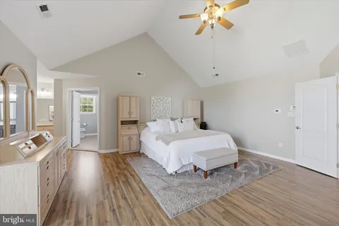 a spacious bedroom with a bed and a chandelier