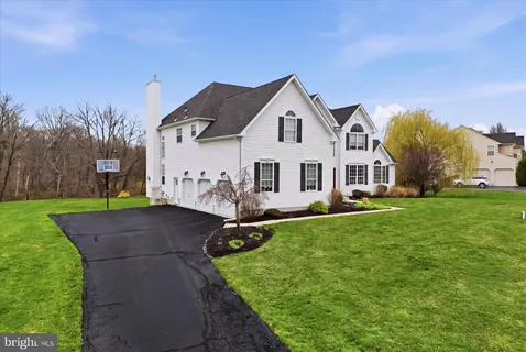 a view of house with yard and green space