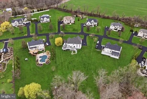 an aerial view of a golf course with chairs and table