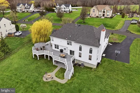 an aerial view of a house with garden space and street view