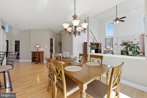 a view of a dining room with furniture and a chandelier