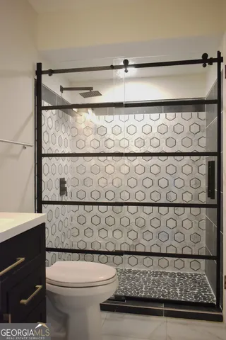 a bathroom with a toilet and a shower curtain