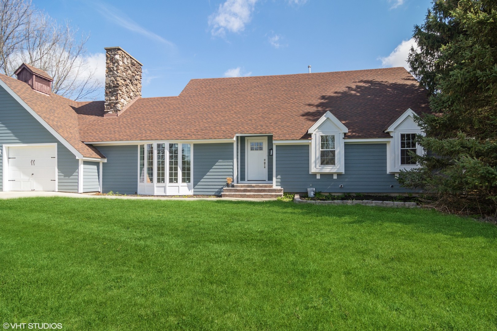 a front view of a house with a garden