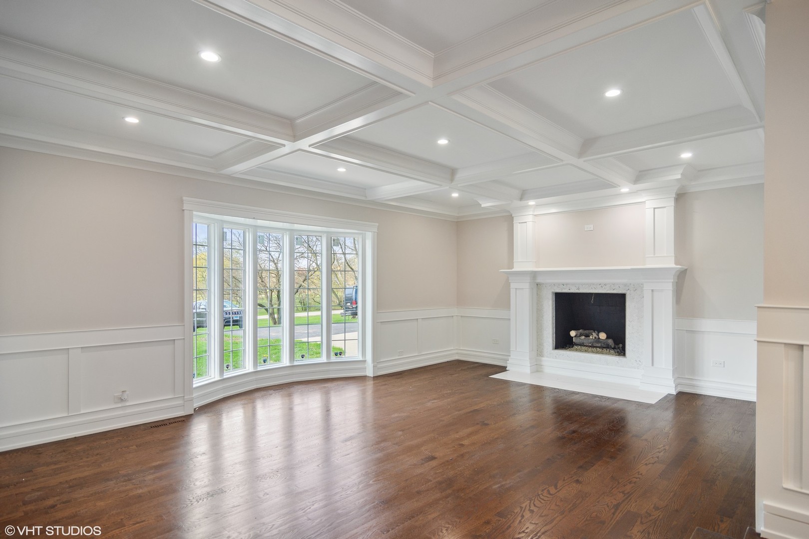 1652 Banbury Road Inverness, IL 60067 - Photo 4 of 28 an empty room with wooden floor fireplace and windows