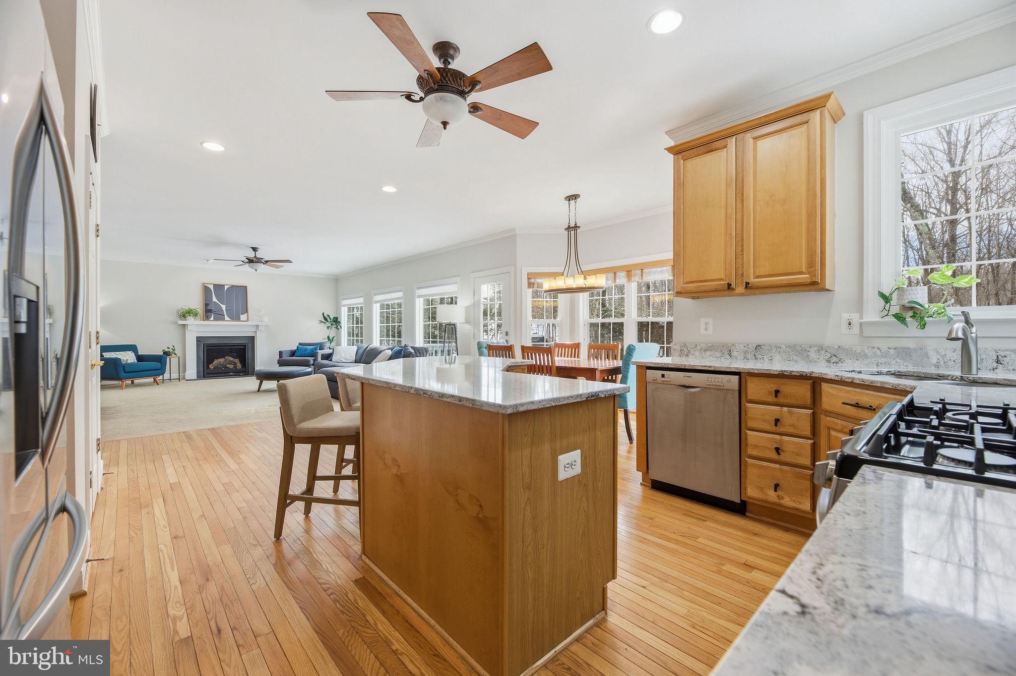 2623 Sequoia Way Prince Frederick, MD 20678 - Photo 24 of 57 a kitchen with stainless steel appliances granite countertop wooden floors a stove a sink and a refrigerator