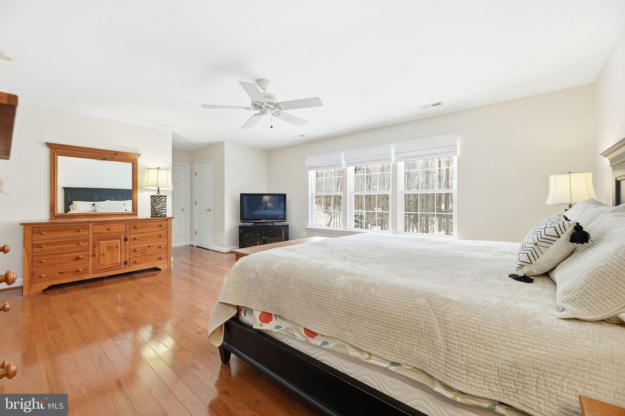2623 Sequoia Way Prince Frederick, MD 20678 - Photo 30 of 57 a bedroom with a bed and wooden floor