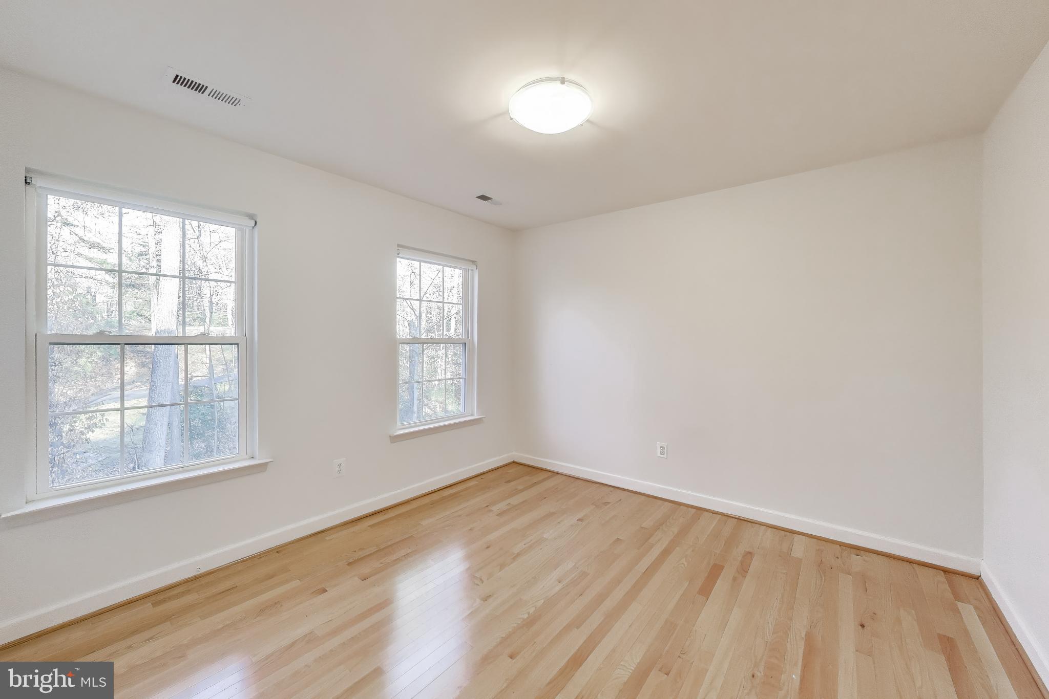 2623 Sequoia Way Prince Frederick, MD 20678 - Photo 33 of 57 an empty room with wooden floor and windows