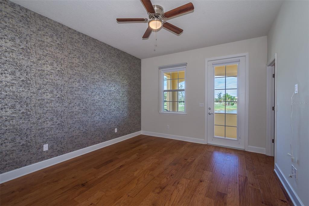 12012 Talitha Lane Orlando, FL 32827 - Photo 14 of 29 wooden floor in an empty room with a window