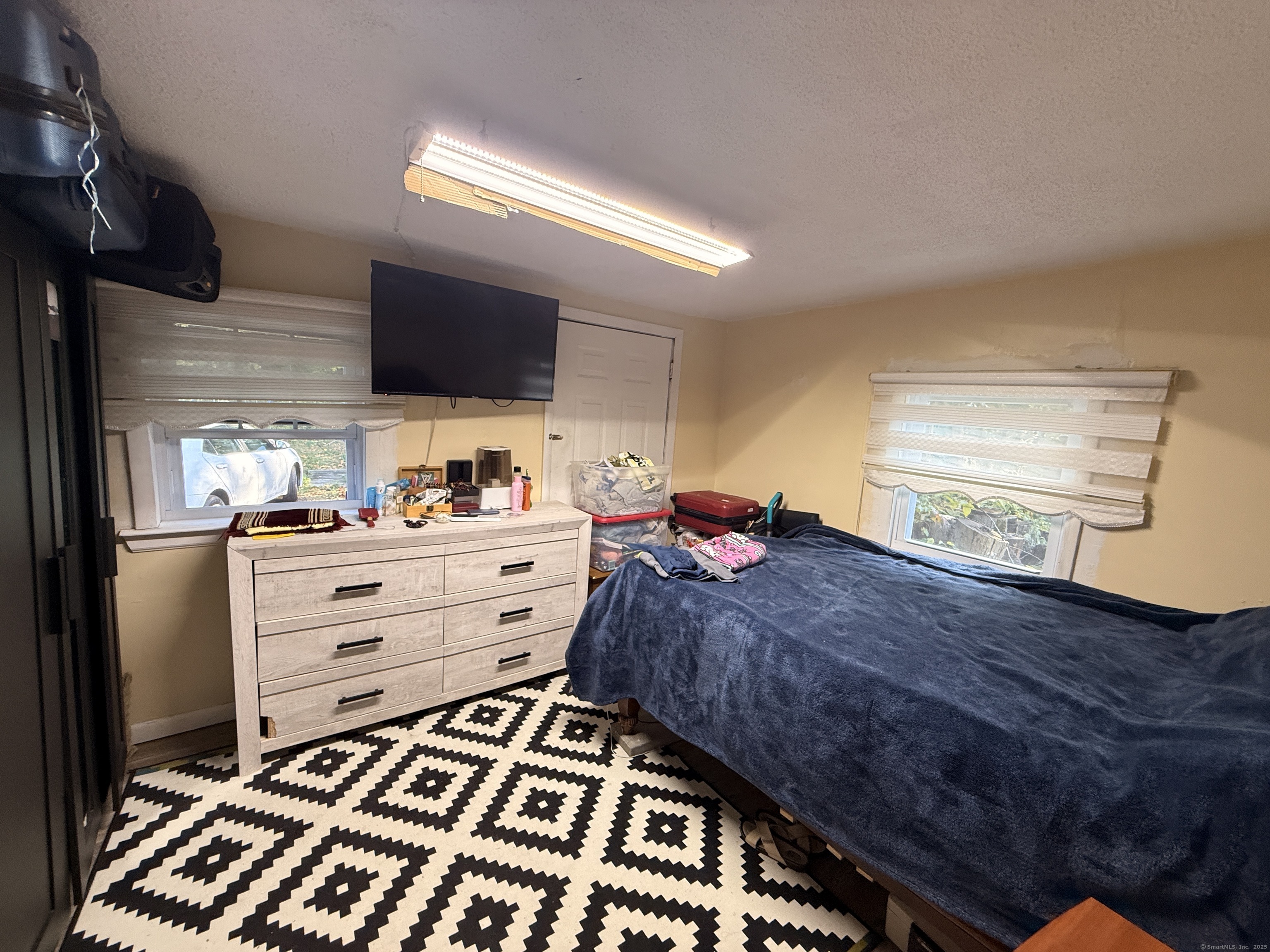 158 East Main Street Bristol, CT 06010 - Photo 11 of 19 a bed room with a bed and a television