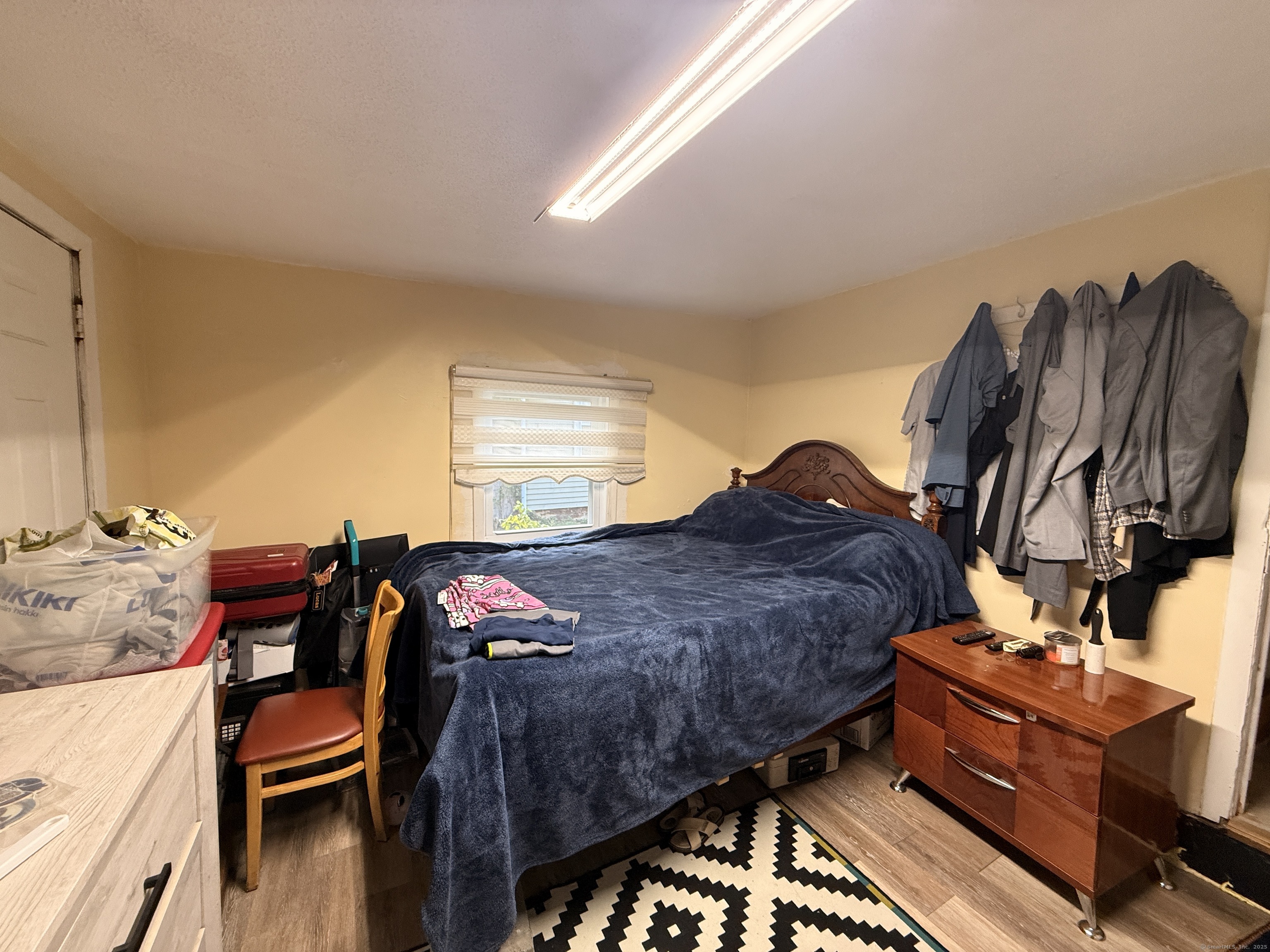 158 East Main Street Bristol, CT 06010 - Photo 12 of 19 a bed sitting in a bedroom next to a window with wooden floor