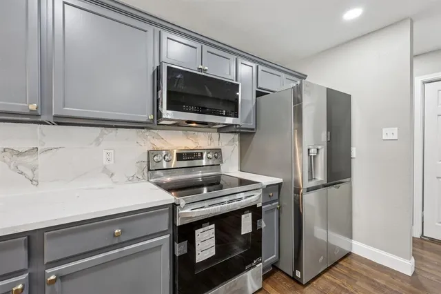 a kitchen with a stove microwave and refrigerator
