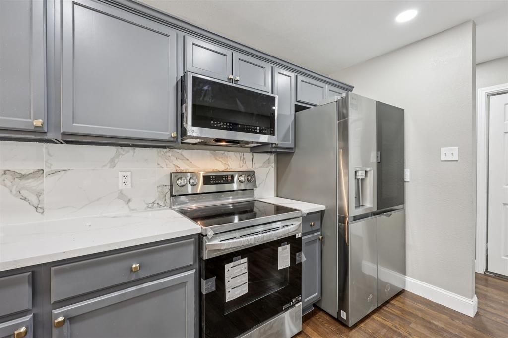 1033 Oak Ridge Drive Azle, TX 76020 - Photo 11 of 30 a kitchen with a stove microwave and refrigerator