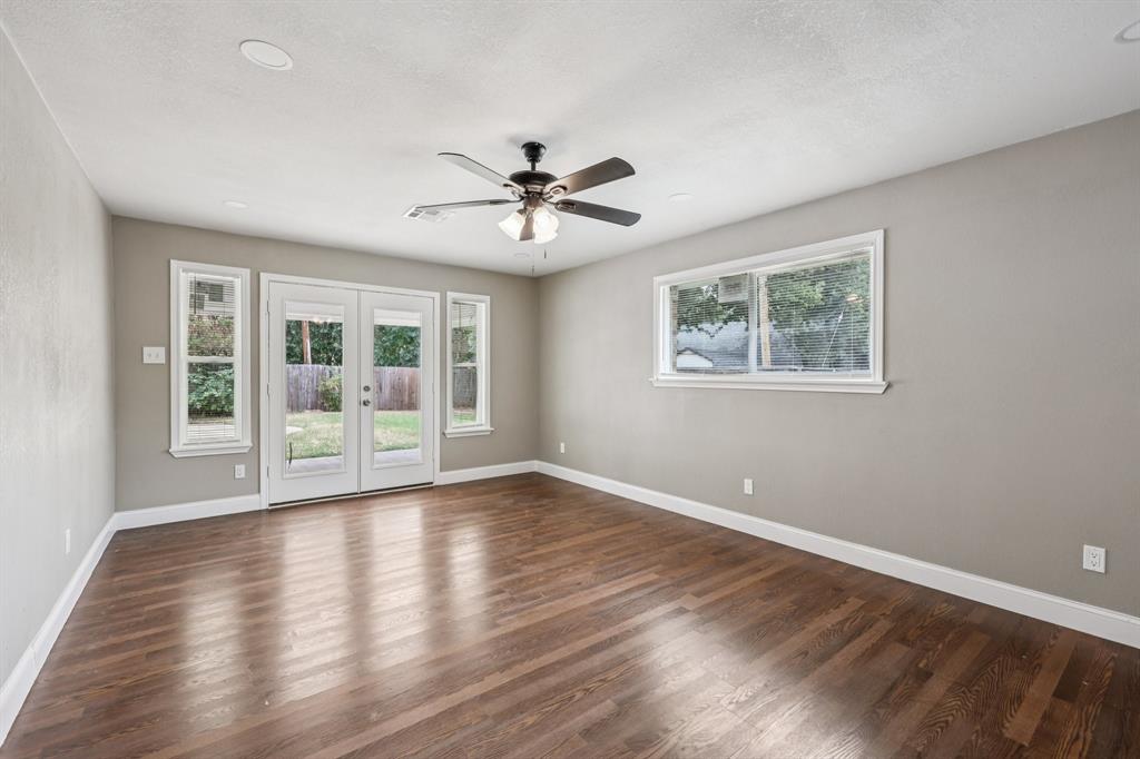 1033 Oak Ridge Drive Azle, TX 76020 - Photo 14 of 30 a view of an empty room with a window and wooden floor