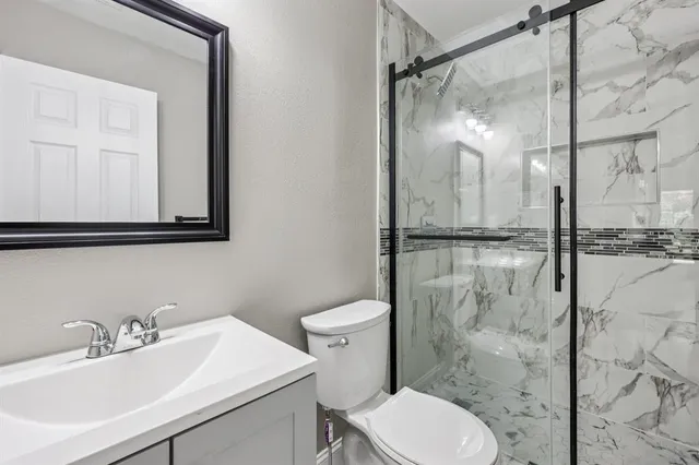 a bathroom with a sink toilet and shower