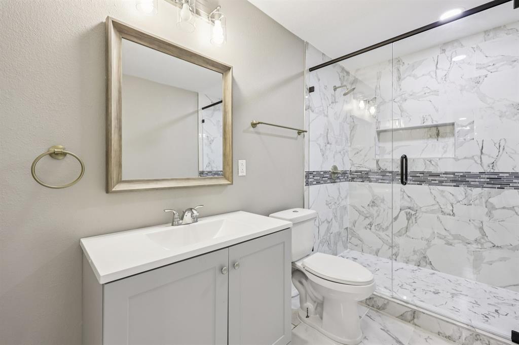 1033 Oak Ridge Drive Azle, TX 76020 - Photo 19 of 30 a bathroom with a sink vanity mirror and toilet