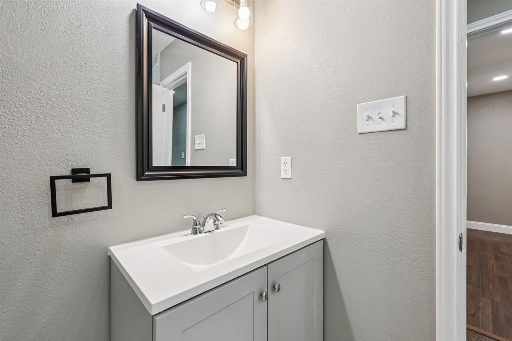 1033 Oak Ridge Drive Azle, TX 76020 - Photo 21 of 30 a bathroom with a sink and a mirror