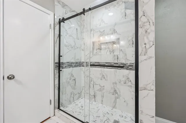 a bathroom with a glass shower door