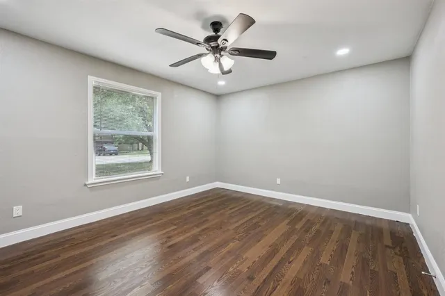 wooden floor in an empty room with a window