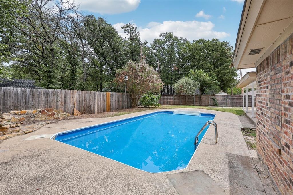1033 Oak Ridge Drive Azle, TX 76020 - Photo 27 of 30 a view of a swimming pool with wooden fence