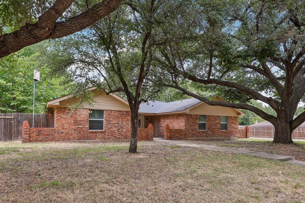 1033 Oak Ridge Drive Azle, TX 76020 - Photo 30 of 30 a front view of a house with a yard and tree