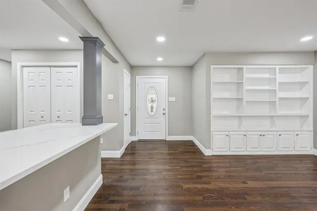 a bathroom with a vanity a sink a large mirror and shower