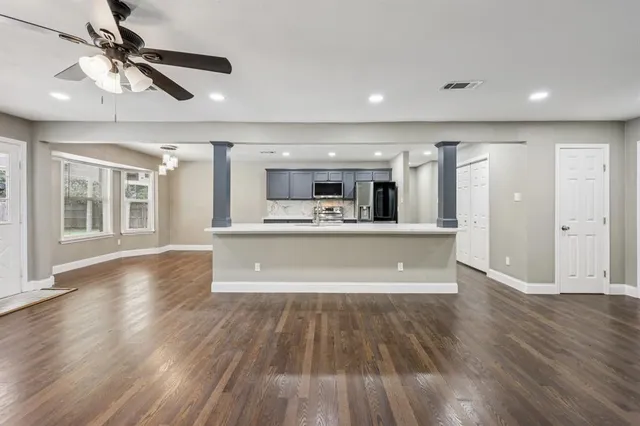 a view of kitchen and hall with wooden floor and a kitchen space with wooden floor