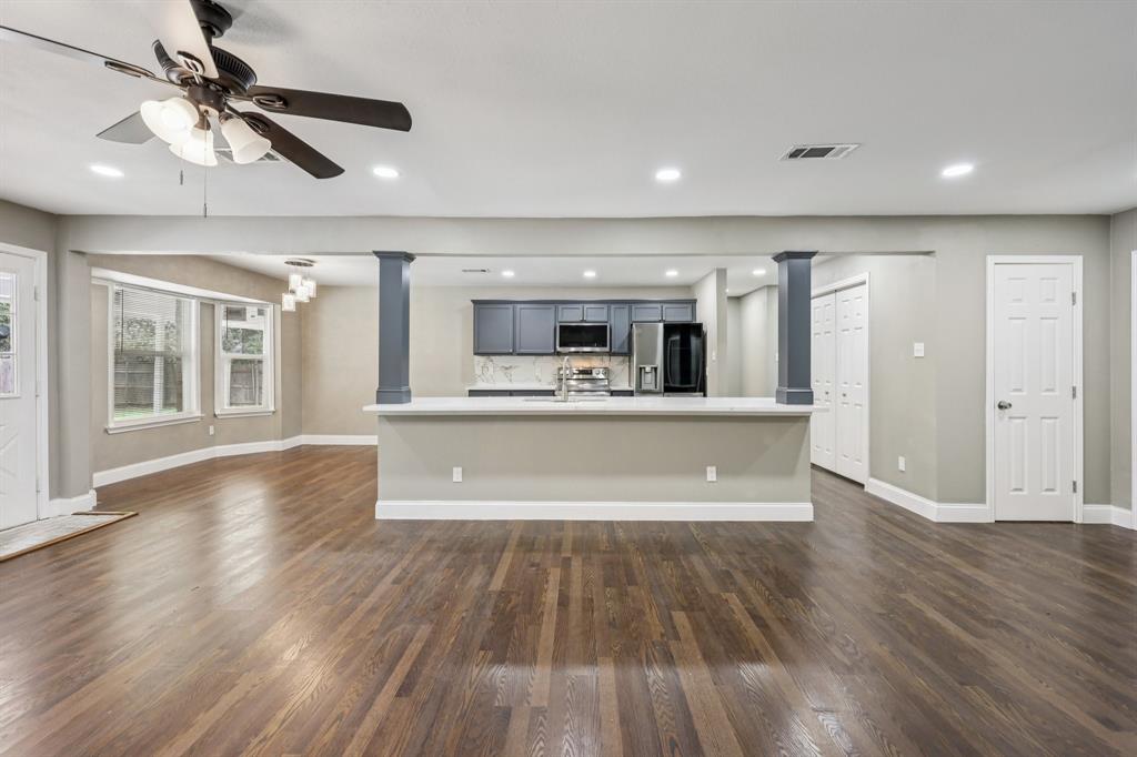 1033 Oak Ridge Drive Azle, TX 76020 - Photo 7 of 30 a view of kitchen and hall with wooden floor and a kitchen space with wooden floor