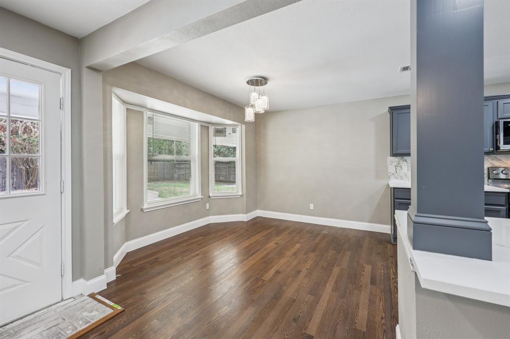 1033 Oak Ridge Drive Azle, TX 76020 - Photo 8 of 30 an empty room with wooden floor and windows