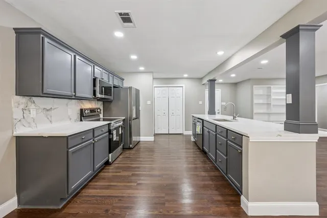 a large kitchen with stainless steel appliances lots of counter top space