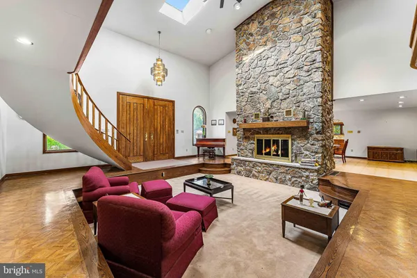 a living room with furniture fireplace and a window