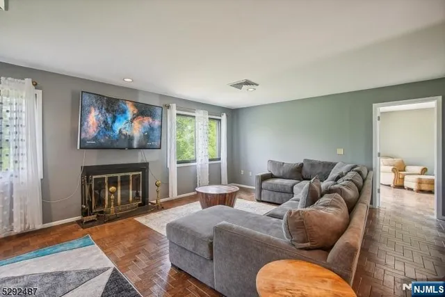 a living room with furniture fireplace and a window
