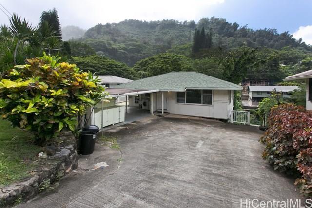 2945 Numana Road Honolulu, HI 96819 - Photo 1 of 1 a house with trees in the background