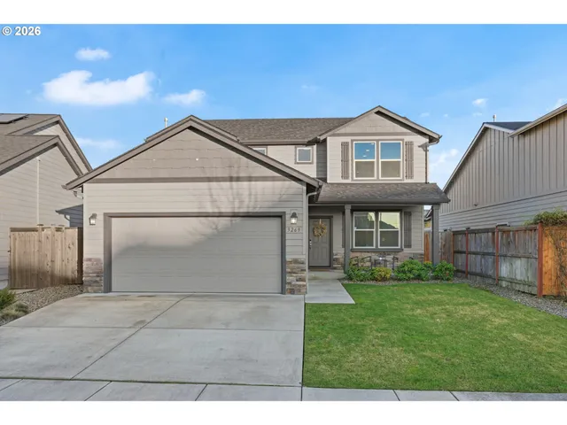 a front view of a house with a yard and garage
