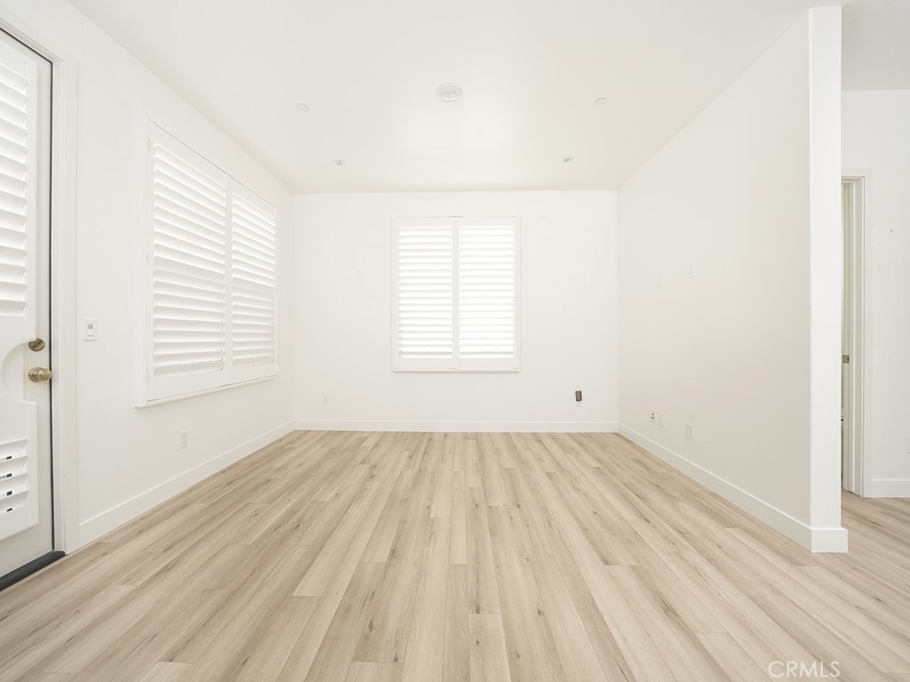 120 Messenger Irvine, CA 92618 - Photo 11 of 26 an empty room with wooden floor and windows